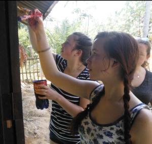 Painting the school to brighten it up on a Thailand community service trip.